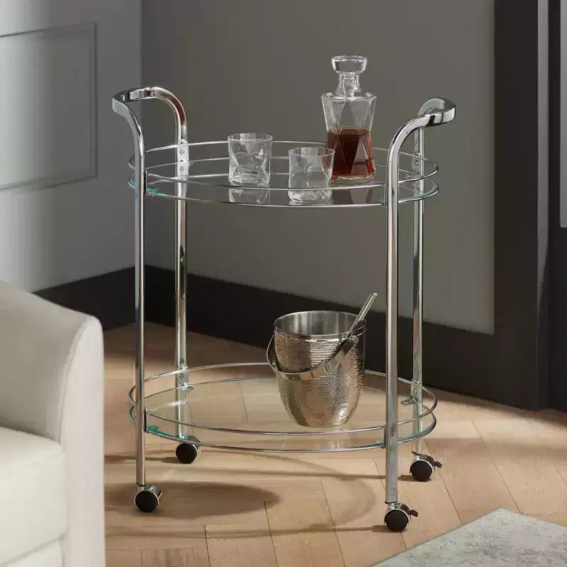 Chariot de service de bar à 2 niveaux en acier chromé moderne Studio 55D Carli, ovale, 66 x 46 cm, argent, avec roulettes et étagères en verre transparent pour salon