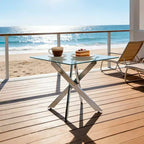 Table à manger avec pieds croisés en métal et plateau en verre trempé, 90x90x75cm, design moderne et peu encombrant pour cuisine ou salon